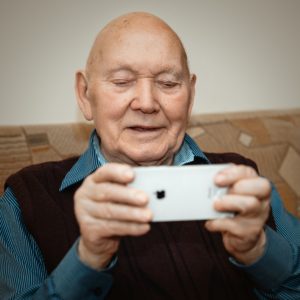 Un vieil homme regardant un iphone